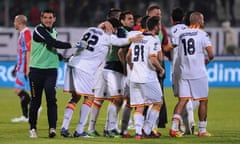 Lecce's players celebrate their team's late victory against Catania