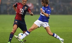 Genoa's Alberto Gilardino, left, is tackled by Sampdoria's Andrea Costa