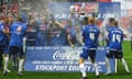 Stockport County players celebrate their promotion to League One