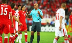 Howard Webb waves away protests after awarding a contentious penalty.