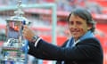 Manchester City manager, Roberto Mancini, celebrates with the FA Cup