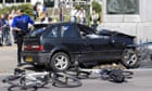 Policemen inspect the car after it collided with bystanders in the Netherlands