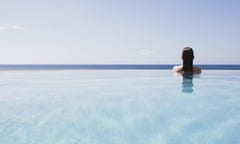 A woman relaxing in an infinity pool