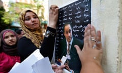 Opposition activists put up posters in Cairo, Egypt