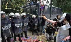 A demonstrator throws streamers towards police in central Athens