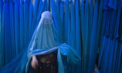 An Afghan woman shops in a local bazaar in Herat