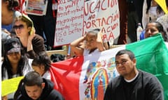 Protesters carry signs in protest of Arizona's new immigration law, April 2010