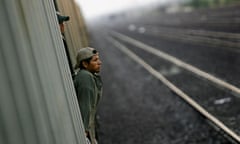 Immigrants travel on a cargo train to the border city of Nuevo Laredo, Mexico