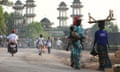 People walk along a road in Makeni, Sierra Leone