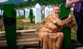 A Bosnian woman cries over newly dug gra