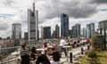 People relax in front of Frankfurt's banking distr