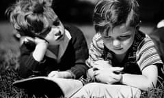 Two boys reading outdoors