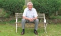 John Cole sitting smiling on a garden bench