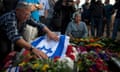 People pay their respects next to the grave of Ariel Sharon