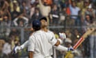 Indian batsman Virender Sehwag is congratulated by teammate Gautam Gambhir