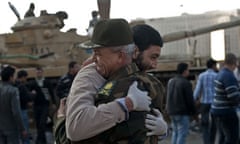 An Egyptian man hugs an army commander in Tahrir Square