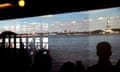 People on the Staten Island ferry look at the Statue of Liberty