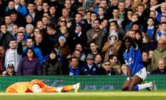 Tottenham Hotspur's goalkeeper Lloris lies injured after a collision with Lukaku 