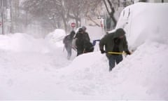 People shovelling mounds of snow in Cambridge, Massachusetts