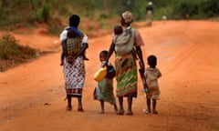 A family walks down a dusty road in Africa