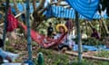 Families of Cambodian migrant workers wait at the Thai border