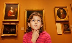 A kid looks up at a painting
