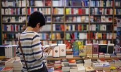 Woman reading books in a bookstore