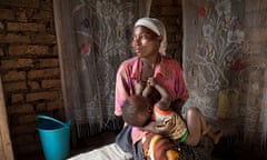A mother nurses a young child in Masaka, Uganda, East Africa.