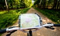 VE cycling: Cyclist With Map Following A Cycle Route Around Brockenhurst, New Forest National Park