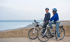 VE Cycling: man and woman on bikes near beach on Isle of Wight