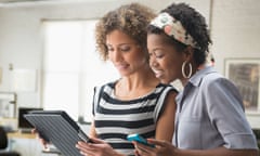 Women using digital tablet in office