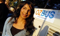 The writer Anita Sethi standing by the OzBus in London