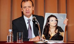 Bill Hawker holds a portrait of his daughter Lindsay Ann Hawker during a press conference in Tokyo