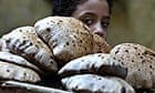 A child carries a tray of bread in Cairo