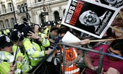 British police officers, left, clash with anti-war protesters gathered at Parliament Square in London during George Bush's visit