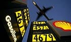 A plane flying over a petrol station