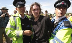 Police officers scuffle with climate change protesters near Kingsnorth power station in Kent