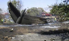 The charred tail section of the crashed SpanAir plane at Madrid's Barajas airport