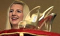 Double Olympic swimming gold medal winner Rebecca Adlington smiles next to her gold Jimmy Choo shoes