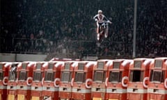 Stuntman Evel Knievel attempting to jump a row of buses, 1975