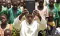 A priest and congregation at a Catholic church in Katine