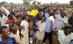 Katine Actors goalkeeper Martin Ojok is held aloft as he celebrates victory over Ojom Ruga Ruga in the over 18s final of the Katine 09 football tournament