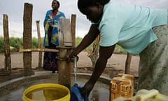 Women pump water from a borehole in  Katine