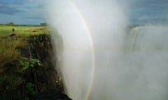 A rainbow forms over the Zambezi River at Victoria Falls.