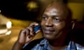 Boniface kamau on his mobile phone