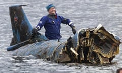 Bill Smith on top of the wreck of Donald Campbell's Bluebird