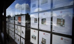 Budget: Property details of houses for sale in the window of a Homefinders esate agents