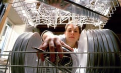 Woman placing saucepan in dishwasher