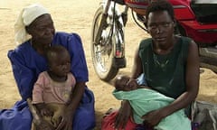 L-R: Martina Abwoso with her daughter-in-law Beatrice Isiina, who is holding the child Abwoso helped deliver two months ago in Katine