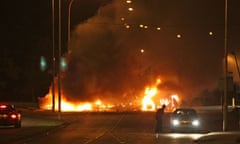 A burning bus blocks the road in Newtownabbey, Northern Ireland